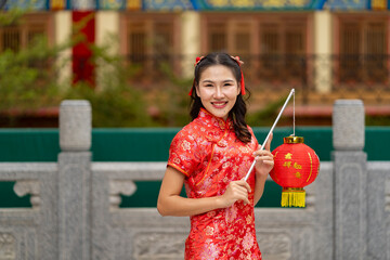 Joyful Woman in Traditional Chinese Attire Celebrating with Lantern