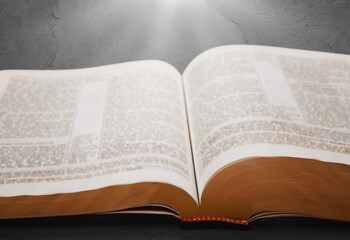 Fototapeta premium Open Bible book on dark background. Religion concept.