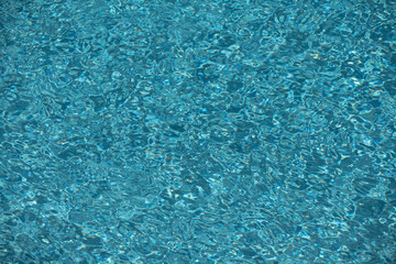 Pool water surface. Water texture. Swimming pool surface. Blue water background. Background of swimming pool water surface.