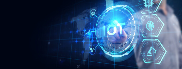 Internet of things - IOT concept. Businessman offer IOT products and solutions. The future of technology. Virtual screen of the future with the inscription: IOT.
