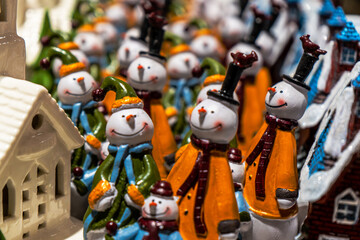 A cheerful collection of festive snowman figurines dressed in colorful hats, scarves, and coats...