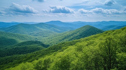Fototapeta premium Lush Green Mountains Under a Blue Sky with Fluffy Clouds in the Distance