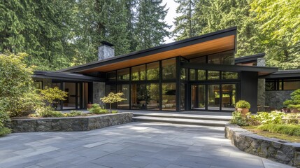 Fototapeta premium Modern architectural design of a house surrounded by lush green trees