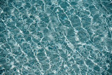 Surface of pool water. Water texture. View of swimming pool surface. Blue water background. Blue water texture background.