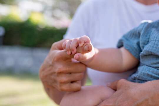 Grandmother bonding with a young child they stand on beach joyful expression feelings of warmth, love and capturing a special moment between the mother and child amidst the beauty nature.
