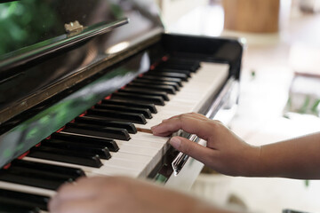 Girl learn to play piano. woman hand playing piano .