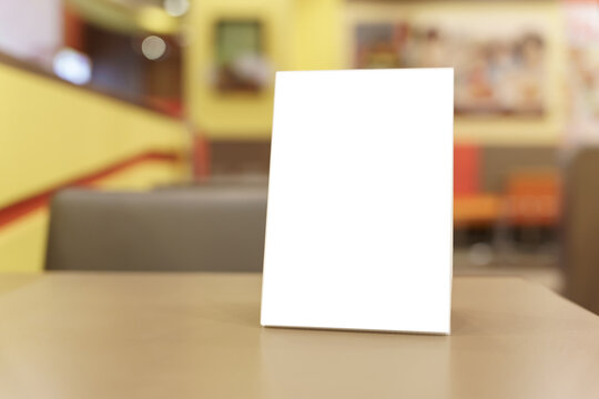 Menu&nbsp;mock up blank for text marketing promotion. Mock up Menu frame standing on wood table in restaurant space for text