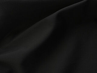 Black cloth fabric abstract background and texture with a beautiful soft blur pattern natural.