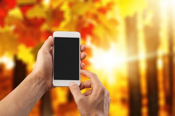 Human hands holding mobile phone with black blank screen