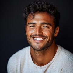Fototapeta premium A young man with casual t-shirt is smiling at the camera, solid color background