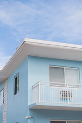 View of building facade. Residential building architecture. Architectural exterior. House exterior fragment. Modern apartment building facade. Apartment building with blue exterior detail