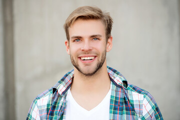 Handsome young man outdoor. Millennial man wearing checkered shirt. Casual style of millennial man....