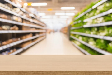 empty  wooden board empty table in front of blurred background. Perspective light wood over blur in supermarket. mock up used for display or montage your products. Wood floor and Supermarket blur.