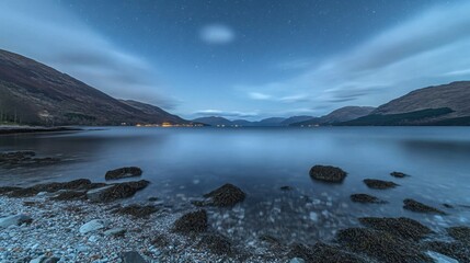 Serene Nightscape Over Calm Waters and Majestic Mountains