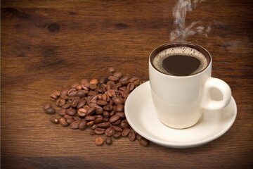 Coffee cup and beans on  desk background