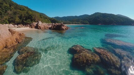 Tranquil Beach Scene with Clear Water and Rocky Shoreline Views