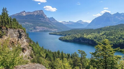 Fototapeta premium Scenic view of a tranquil lake surrounded by mountains and lush greenery under a blue sky.