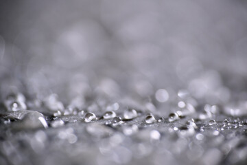 Macro shot of water droplet on waxy floor surface