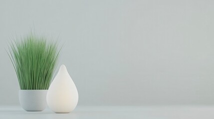 A minimalist arrangement featuring a green plant in a white pot beside a soft, glowing lamp, set against a light gray background.