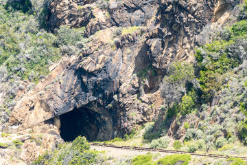 tunnel in or through a mountain with a railway line concept infrastructure and engineering industry