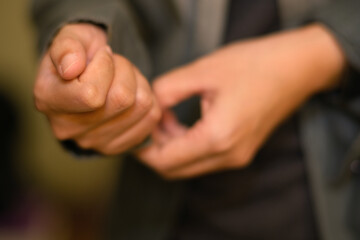 Obraz premium Closeup of a woman hands buttoning a shirt
