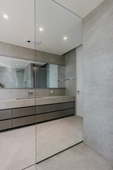It is common to divide the space in the bathroom with a glass partition
