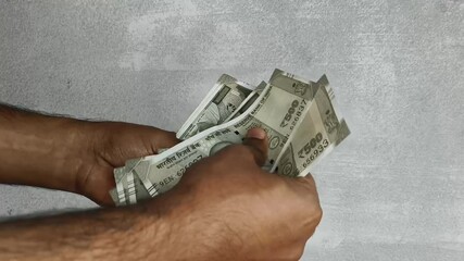 Hand counting bunch of indian currency, money or bank notes bundle of five hundred rupee. Close up macro top view. Financial, savings, economy, business, salary and investment concept background.
