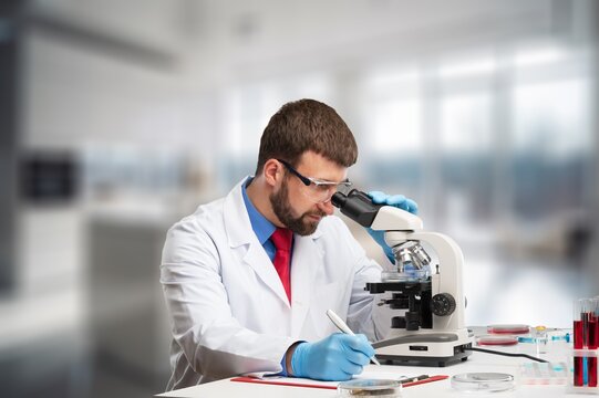 Sientist research with microscope at laboratory for medical study