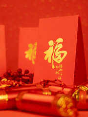 Naklejka premium Chinese new year festival decorations with red bags, oranges and red Chinese folded fans on white marble background. Celebrate Happy Chinese new year. All Brushscript Texts in Chinese meaning luck.