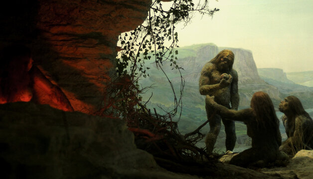 Primal tribe of ancient wild people animal skin and stone axes eating frying meat on bonfire staying in cave. Neanderthals. Ice age.