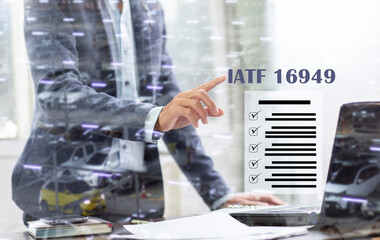 businessman point to IATF 16949 and document list at office desk, Automotive Quality Management System  