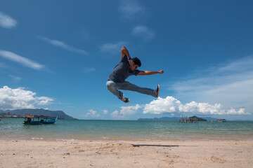 person jumping on the beach
