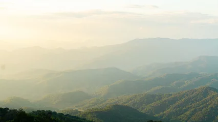 Poster serene landscape showcasing rolling mountains under soft, hazy sky. lush greenery and gentle slopes create tranquil atmosphere, perfect for nature lovers