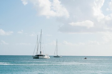 Sailboats and jet ski on a calm sea