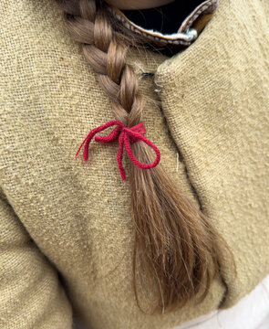 A girl with a red ribbon in her hair