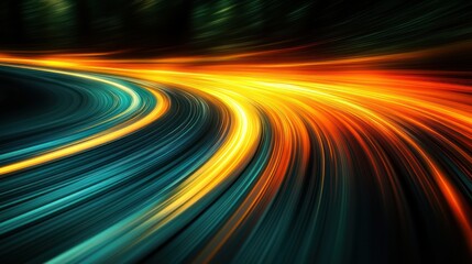 Abstract light trails of a speeding car on a curved road at night.