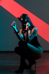 Sensual Portrait of a Woman in a Cat Mask and Handcuffs Showcasing a Striking BDSM Concept Against...