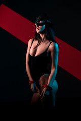 Portrait of a Woman Wearing a Cat Mask and Handcuffs, Embodying a Bold BDSM Aesthetic in a Contemporary Setting With Neon Accents