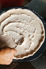 making pizza spreading souse cheese white garlic