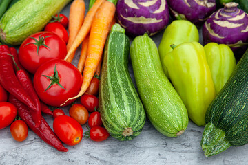 Close-up of fresh vegetables - carrots, peppers, zucchini, tomatoes and kohlrabi cabbage - for health and cooking, wellness and nutrition. Vegetables, organic produce and cuisine with dinner or lunch