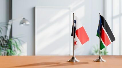 FLAGS OF PANAMA AND SOUTH SUDAN ON TABLE