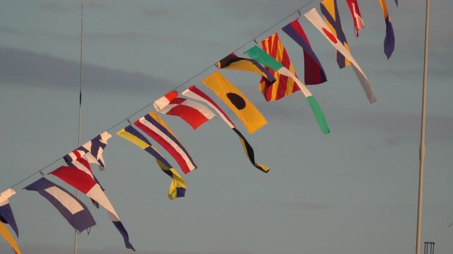 Various nautical flags tied together with rope, Ship flags signals, morse code,