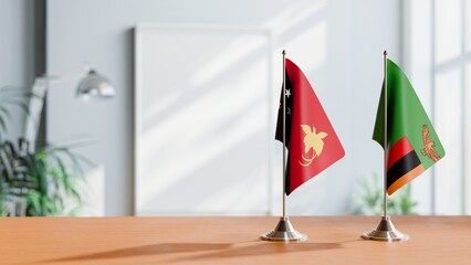 FLAGS OF PAPUA NEW GUINEA AND ZAMBIA ON TABLE