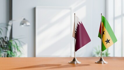 FLAGS OF QATAR AND SAO TOME ON TABLE