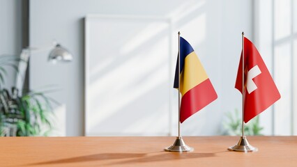 FLAGS OF ROMANIA AND SWITZERLAND ON TABLE