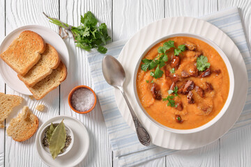 creamy carrot beef soup in a white bowl