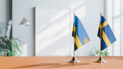 FLAGS OF RWANDA AND SWEDEN ON TABLE