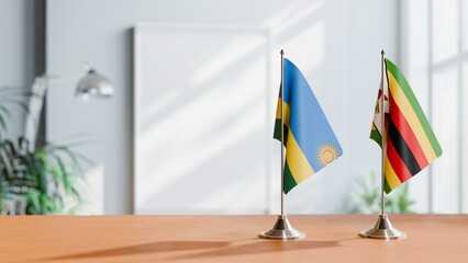 FLAGS OF RWANDA AND ZIMBABWE ON TABLE