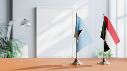 FLAGS OF SAINT LUCIA AND SUDAN ON TABLE