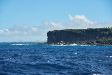 Fototapeta premium Coin de Mire (Gunner's Quoin), a protected Mauritian island 8 km off Mauritius' northern coast, is known for its steep profile and birdlife but is not open to visitors.